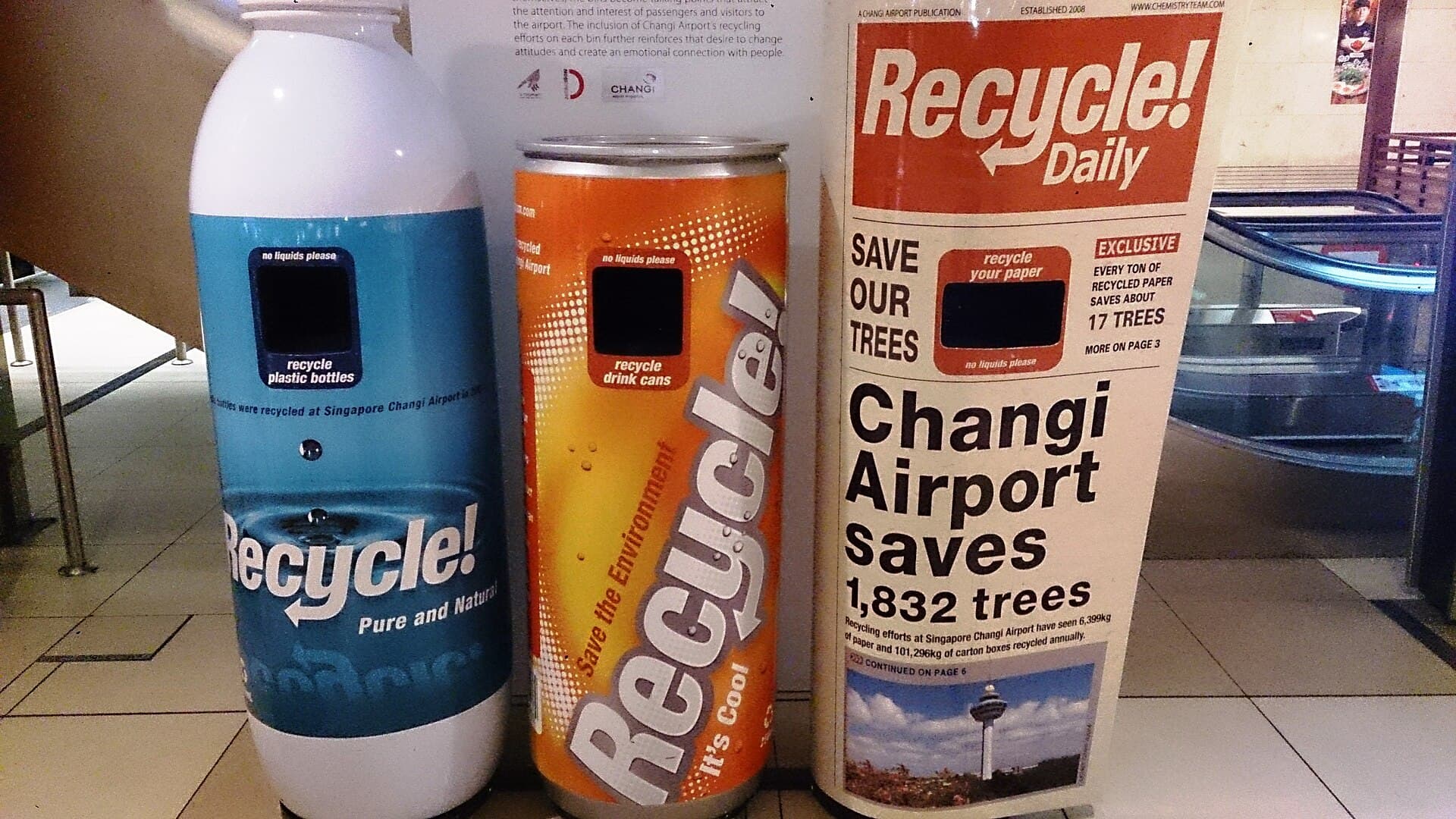 Colour-coded recycling bins in a public concourse