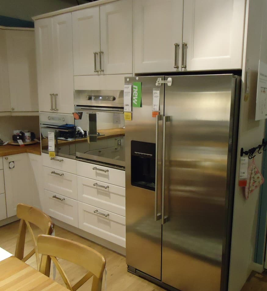 Commercial kitchen with stainless benches and timber cabinets